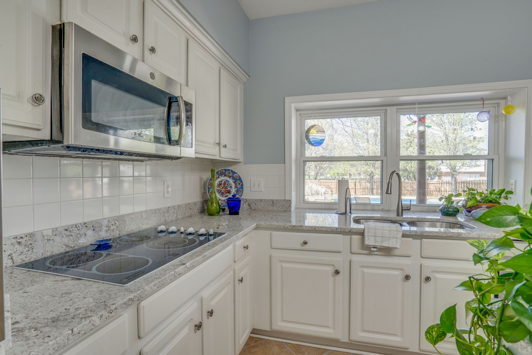 305 Knowle Place Franklin, TN 37069 - Photo 17 of 34 a kitchen with granite countertop white cabinets white appliances a sink and a window