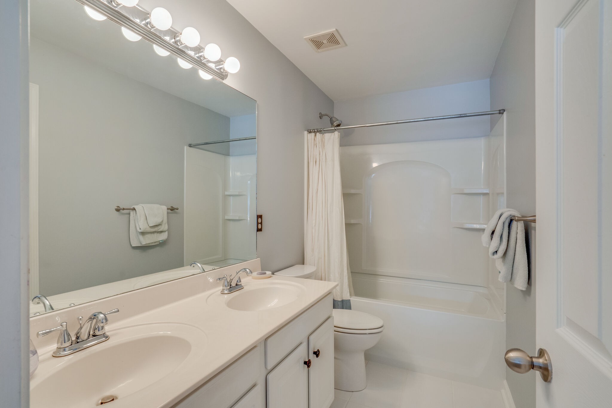 305 Knowle Place Franklin, TN 37069 - Photo 20 of 34 a bathroom with a double vanity sink toilet mirror and shower