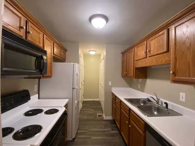 a kitchen with a sink a stove and cabinets