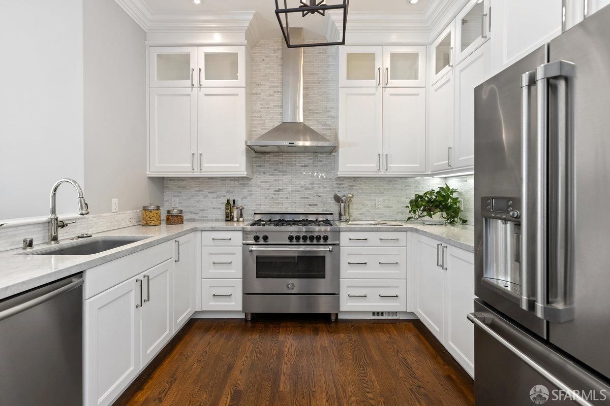 369 Day Street San Francisco, CA 94131 - Photo 6 of 54 a kitchen with stainless steel appliances a stove sink and refrigerator