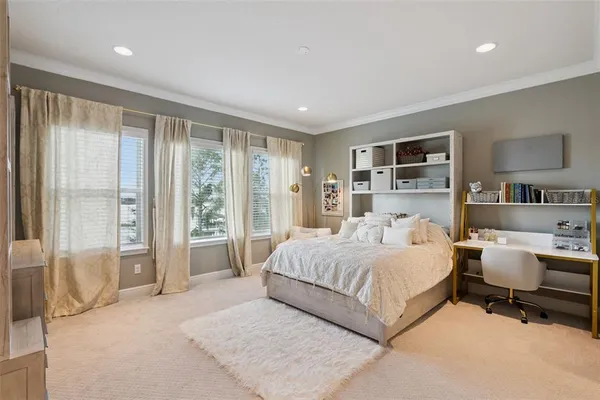 a living room with furniture and floor to ceiling windows