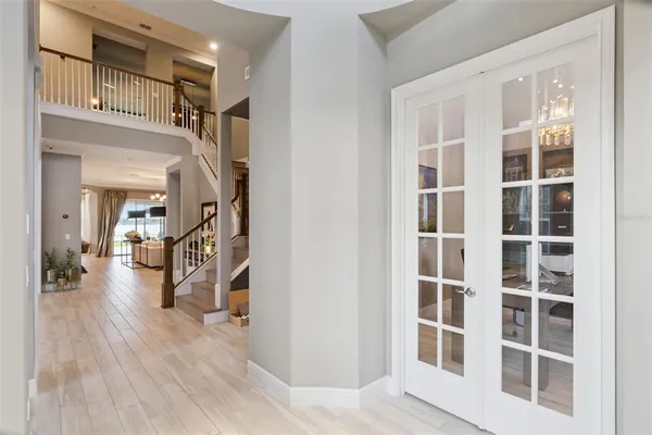 a view of a living room with wooden floor and windows