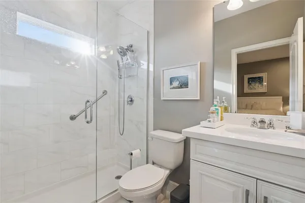 a living room with patio furniture and a floor to ceiling window