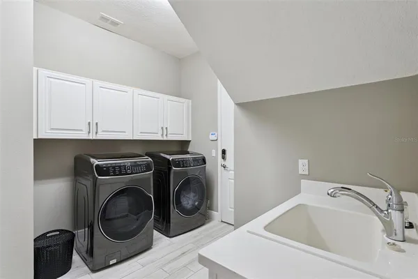 an aerial view of a house with outdoor space and lake view in back