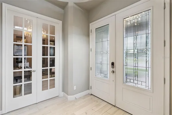 a view of an entryway with wooden floor and windows