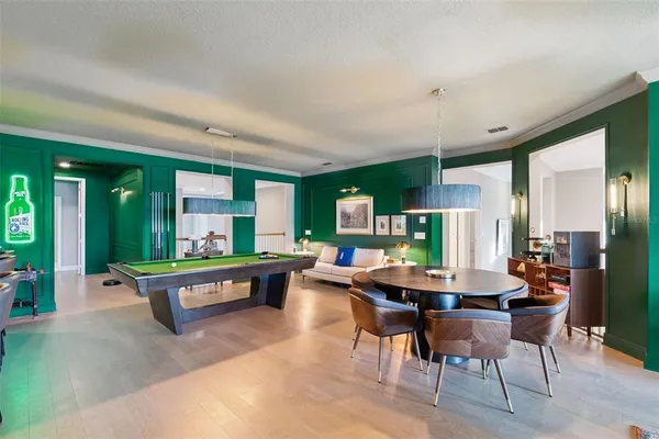 a view of a white house with a yard and potted plants