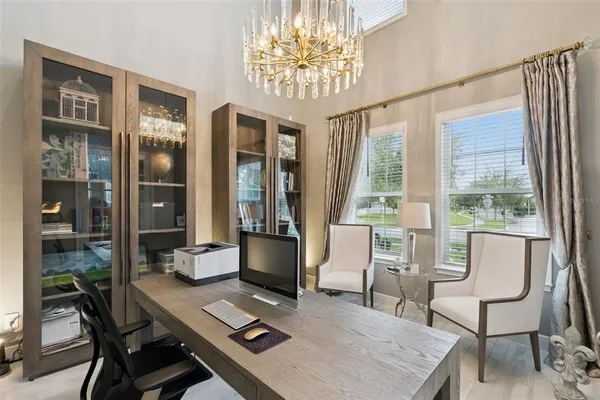 a view of a house with a yard and large tree