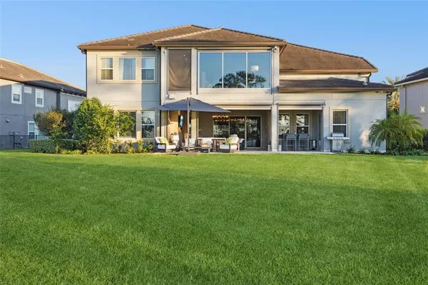 a view of a dining room with furniture chandelier and a large window
