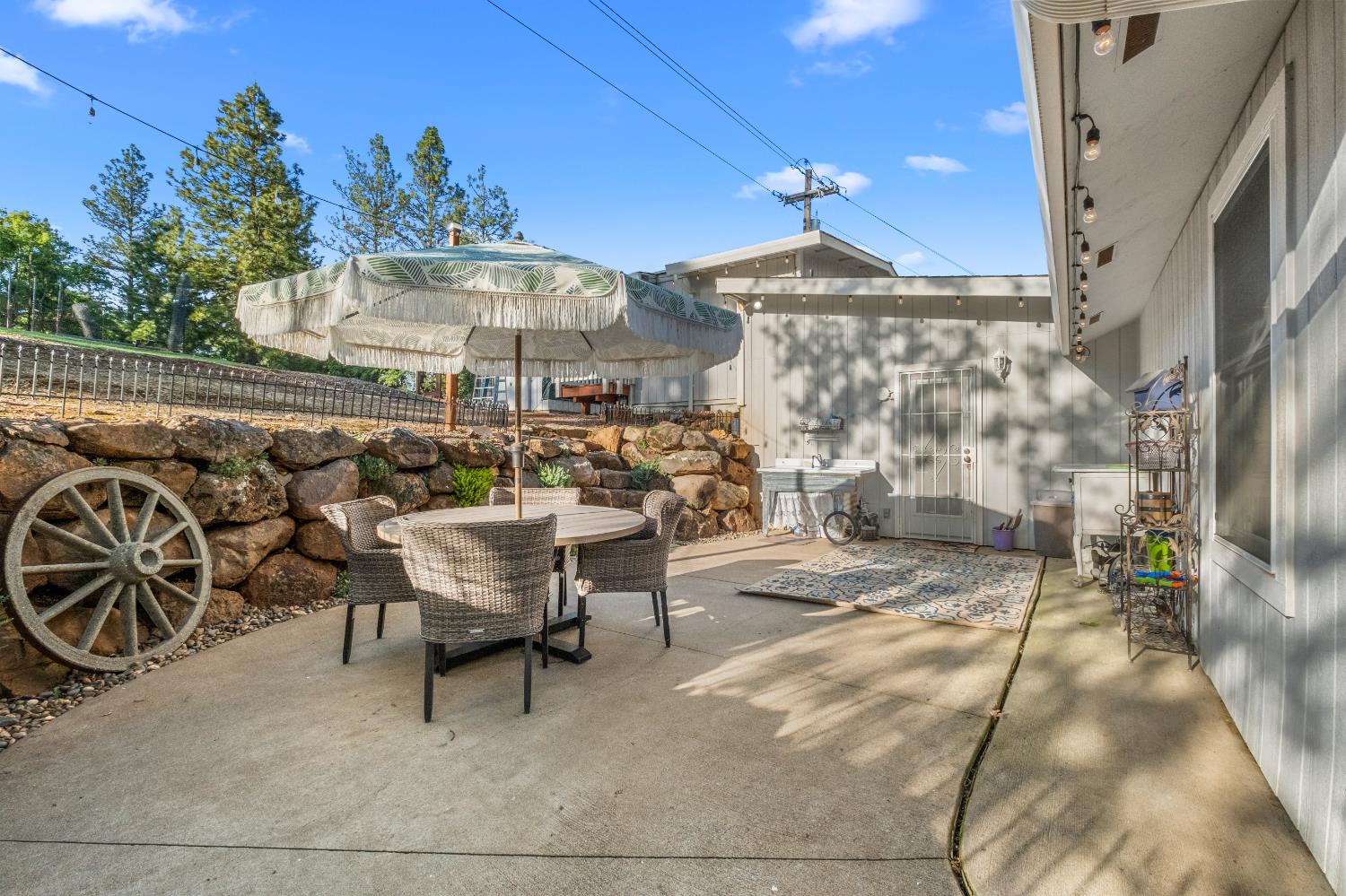 3217 Pleasant Valley Road Placerville, CA 95667 - Photo 32 of 59 a view of a patio with table and chairs potted plants
