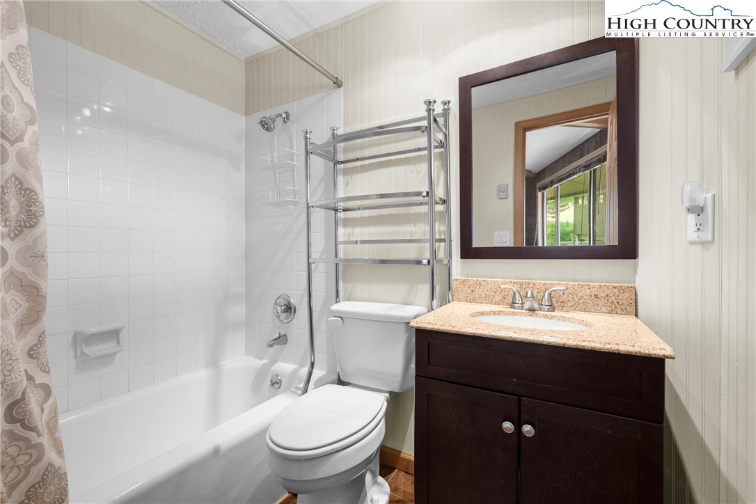 315 Timber Ridge Road, Unit A3 Sugar Mountain, NC 28604 - Photo 22 of 27 a bathroom with a sink toilet and shower