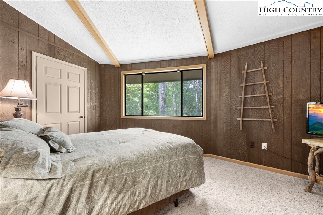 315 Timber Ridge Road, Unit A3 Sugar Mountain, NC 28604 - Photo 23 of 27 a bedroom with a bed and a window