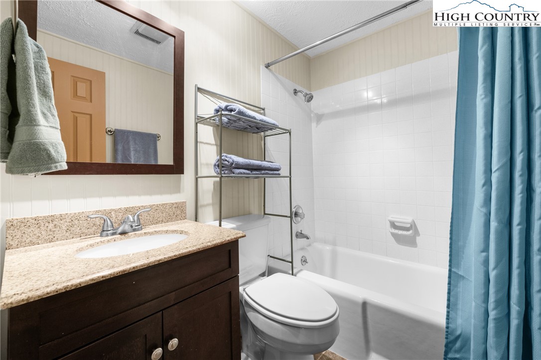 315 Timber Ridge Road, Unit A3 Sugar Mountain, NC 28604 - Photo 25 of 27 a bathroom with a sink toilet vanity and shower