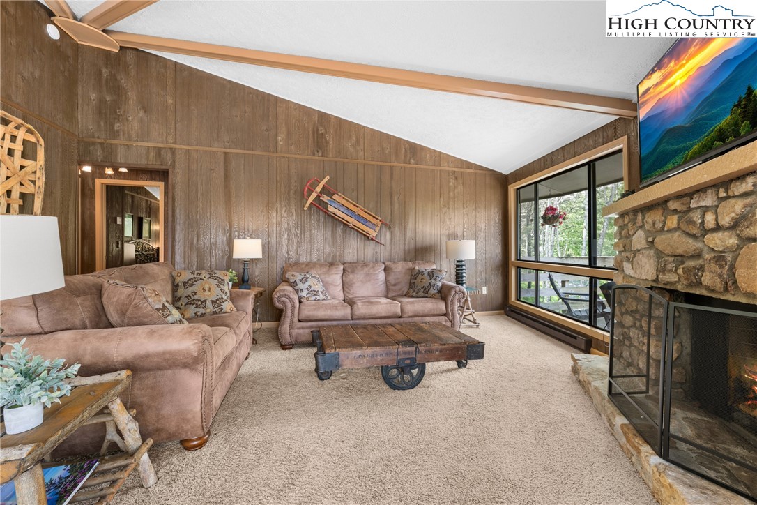 315 Timber Ridge Road, Unit A3 Sugar Mountain, NC 28604 - Photo 4 of 27 a living room with furniture fireplace and flat screen tv