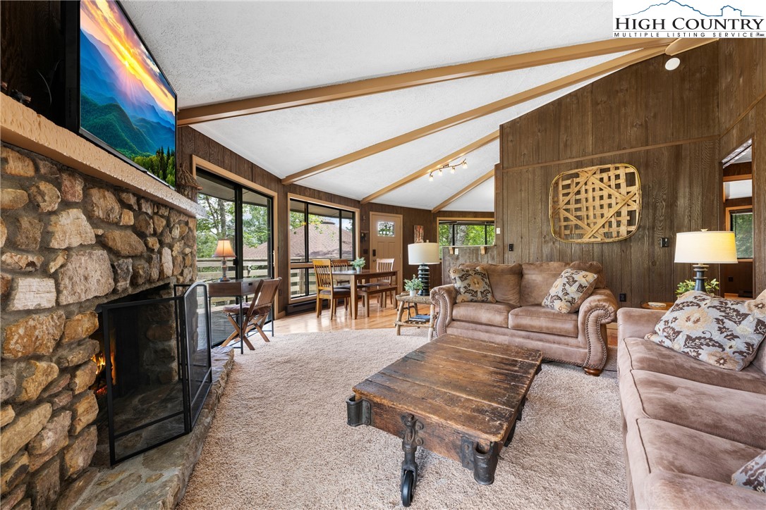 315 Timber Ridge Road, Unit A3 Sugar Mountain, NC 28604 - Photo 5 of 27 a living room with furniture and a fireplace