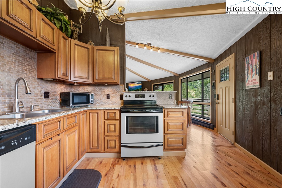 315 Timber Ridge Road, Unit A3 Sugar Mountain, NC 28604 - Photo 9 of 27 a kitchen with stainless steel appliances granite countertop a stove and a sink