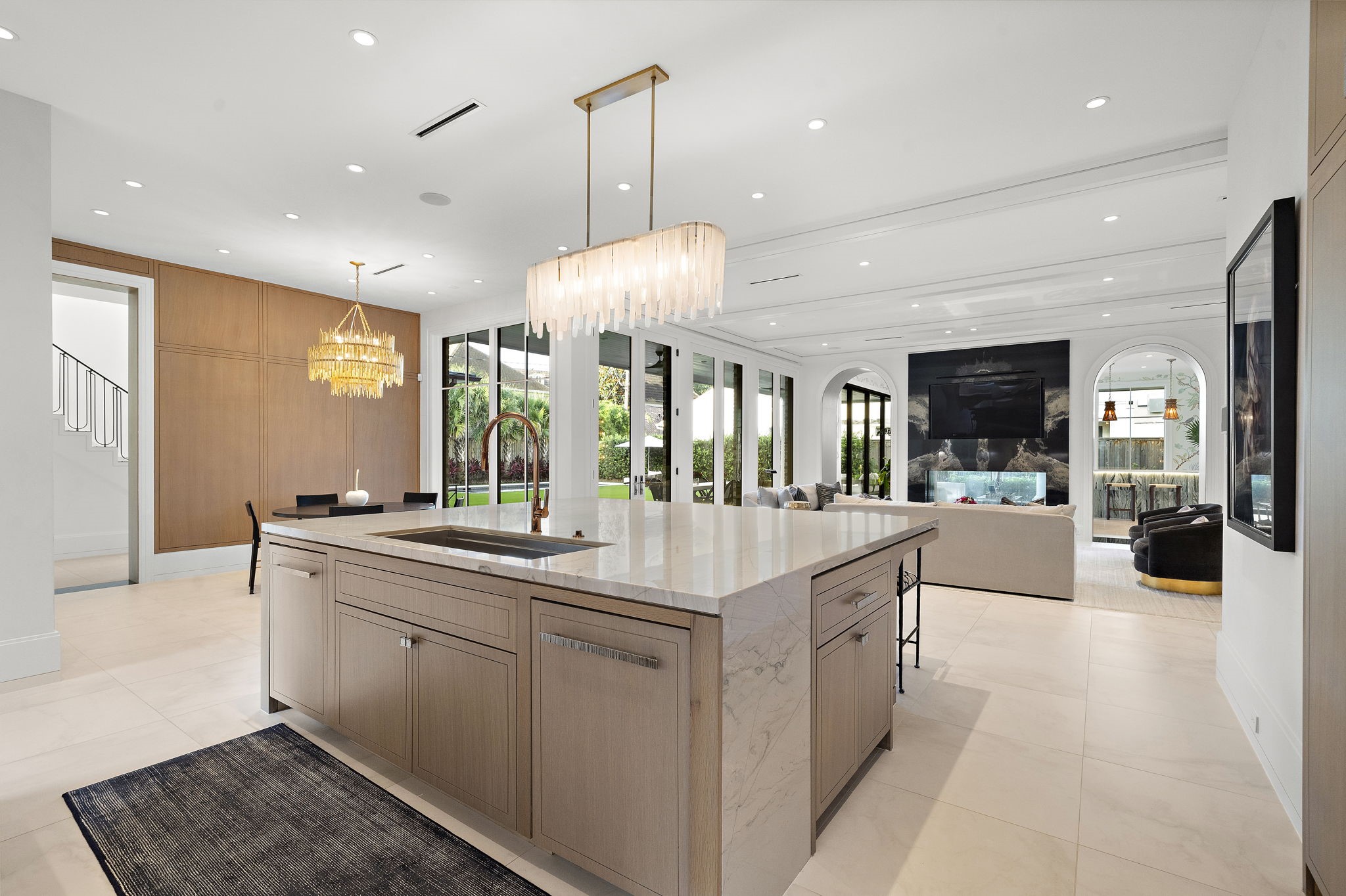 3649 Chevy Chase Drive Houston, TX 77019 - Photo 14 of 50 Designed for effortless living, the open kitchen connects directly to the main living spaces, outdoor entertaining areas, and catering corridor for unmatched functionality.