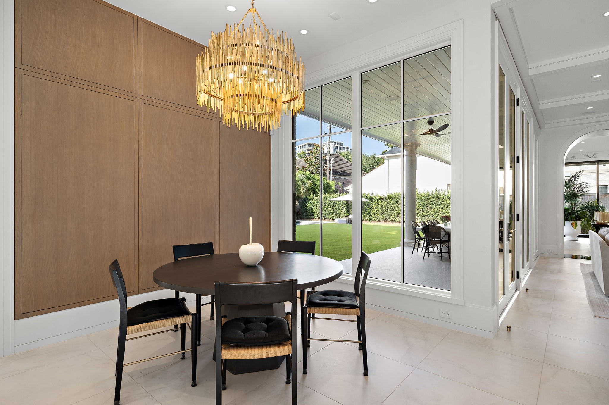 3649 Chevy Chase Drive Houston, TX 77019 - Photo 15 of 50 Peaceful views and a warm wood accent wall define this light-filled informal dining area, ideal for relaxed, everyday living.