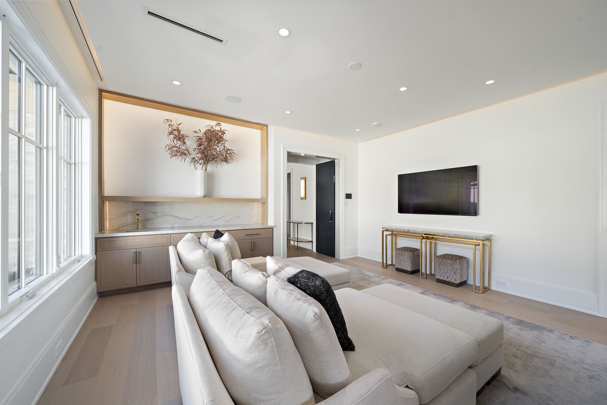3649 Chevy Chase Drive Houston, TX 77019 - Photo 28 of 50 A backlit feature wall and quartzite bar elevate the primary suite’s sitting area, combining natural stone luxury with sleek, modern detailing.
