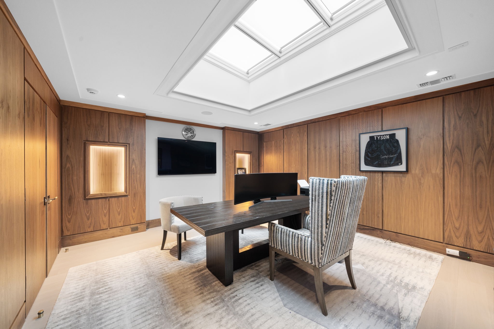 3649 Chevy Chase Drive Houston, TX 77019 - Photo 39 of 50 A 15' x 17' study wrapped in walnut paneling, built-in cabinetry with quartzite, lighted art niches, and an oversized skylight that fills the space with natural light.