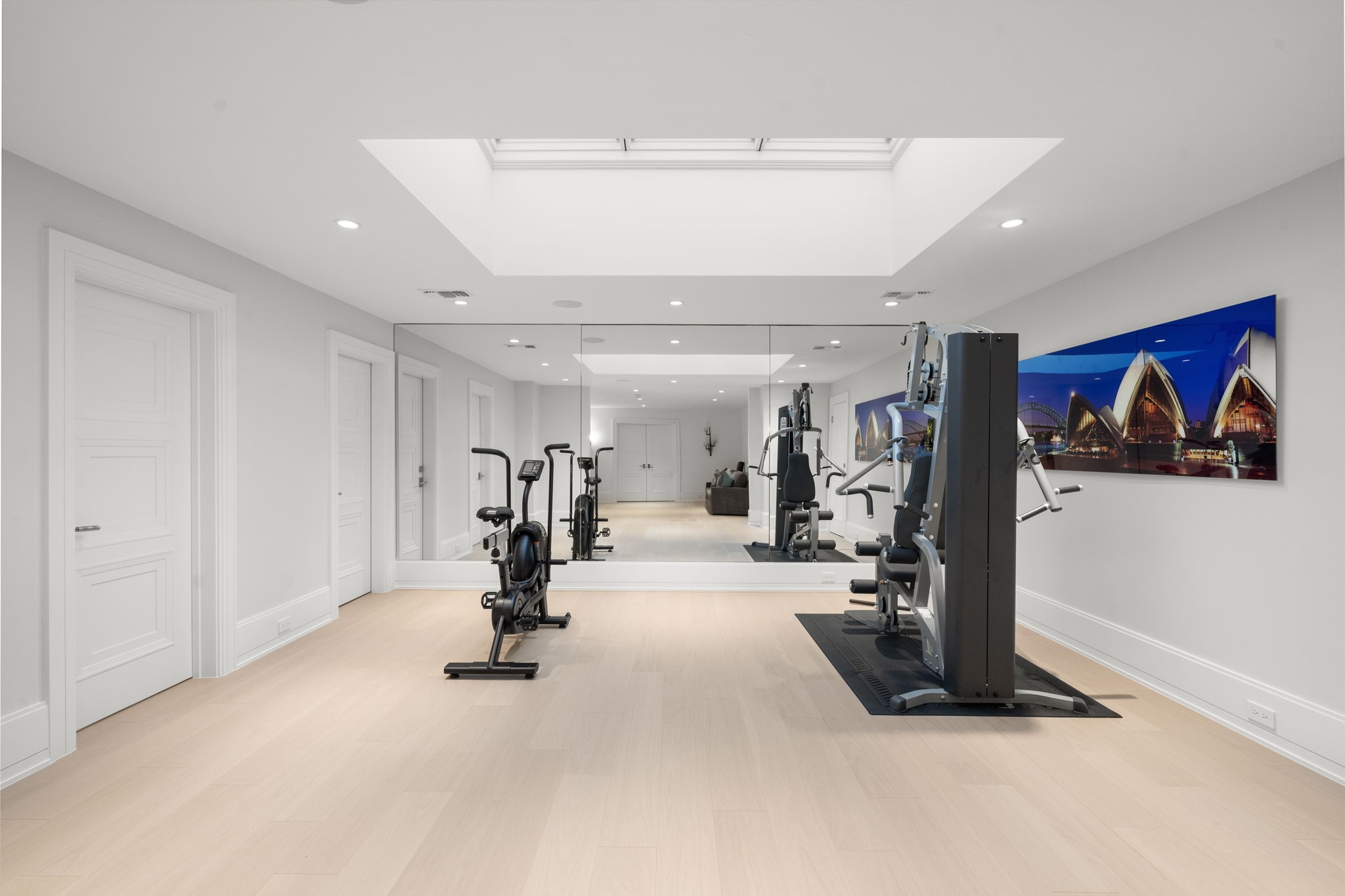 3649 Chevy Chase Drive Houston, TX 77019 - Photo 41 of 50 A light-filled third-floor gym with mirrored wall and skylight, connected to a versatile flex space with built-in bar and beverage fridge. The adjacent wellness suite features a steam shower and sauna, creating a private spa experience within the home.