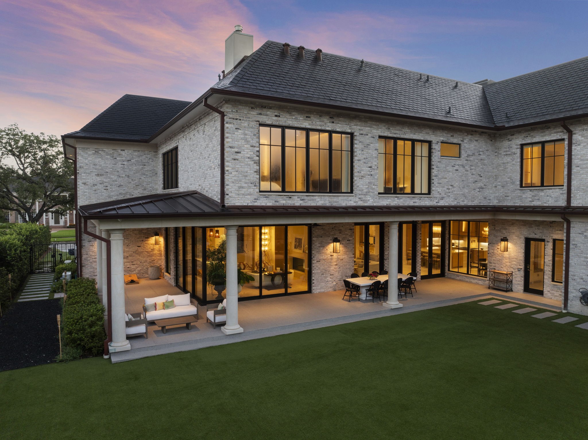 3649 Chevy Chase Drive Houston, TX 77019 - Photo 45 of 50 Timeless slate roof crowns this elegant exterior, complemented by expansive covered patios ideal for outdoor dining and lounging. The low-maintenance turf yard offers generous space for play and entertaining.