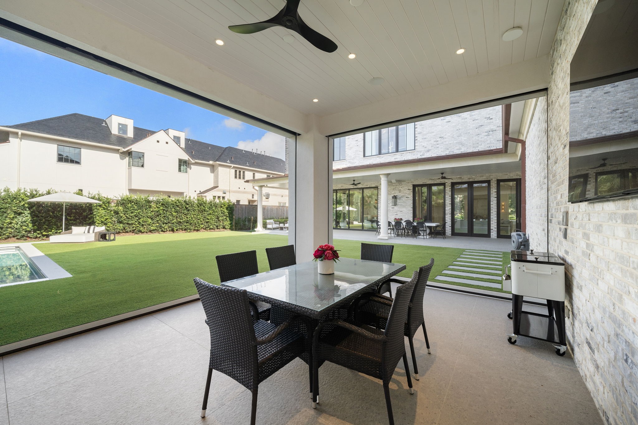 3649 Chevy Chase Drive Houston, TX 77019 - Photo 48 of 50 Elegant loggia with retractable screens offers seamless indoor-outdoor living, perfect for year-round lounging and entertaining in comfort and style.