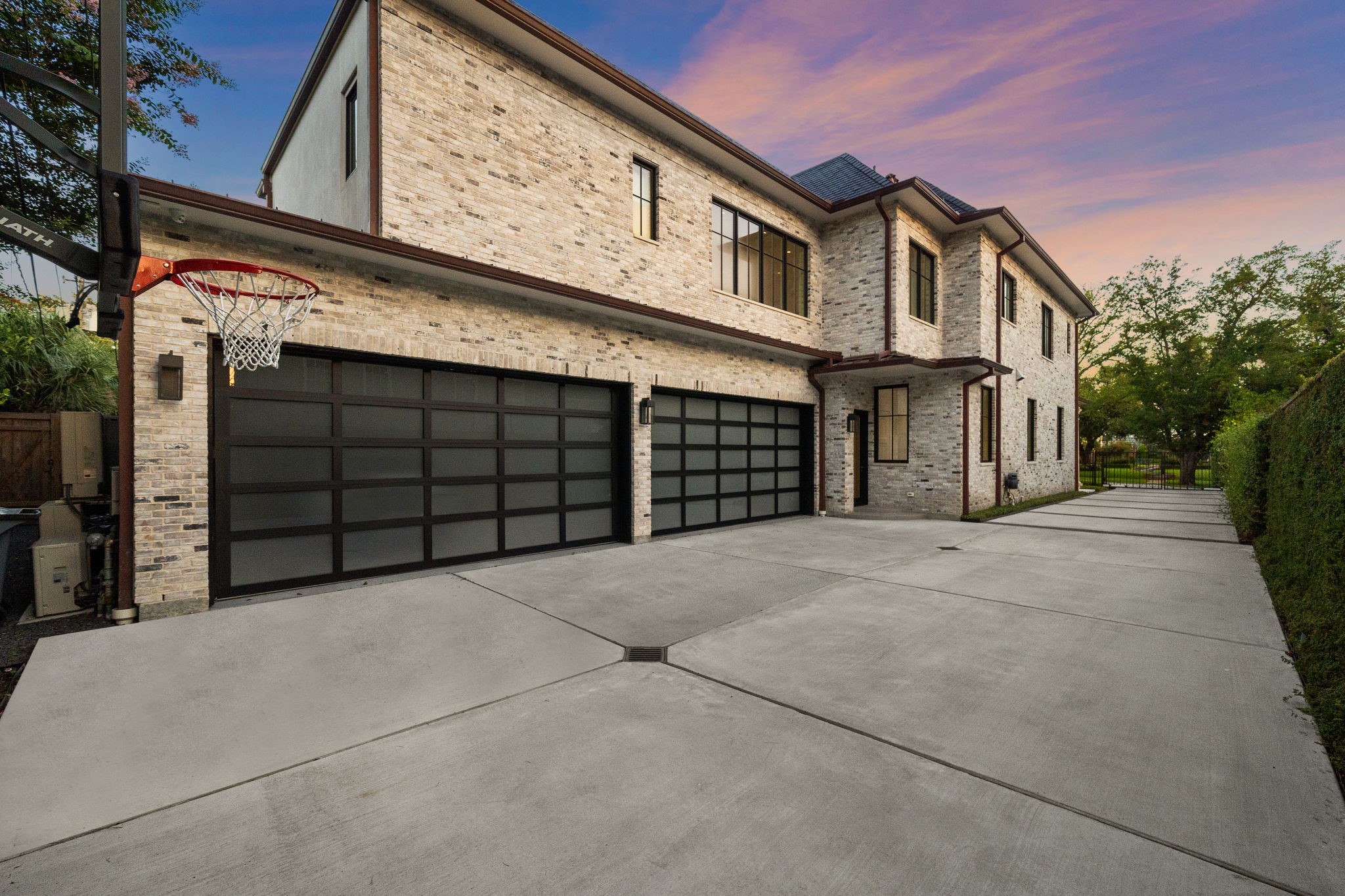 3649 Chevy Chase Drive Houston, TX 77019 - Photo 50 of 50 Oversized four-car garage with epoxy floors, gated driveway, and classic brick exterior.