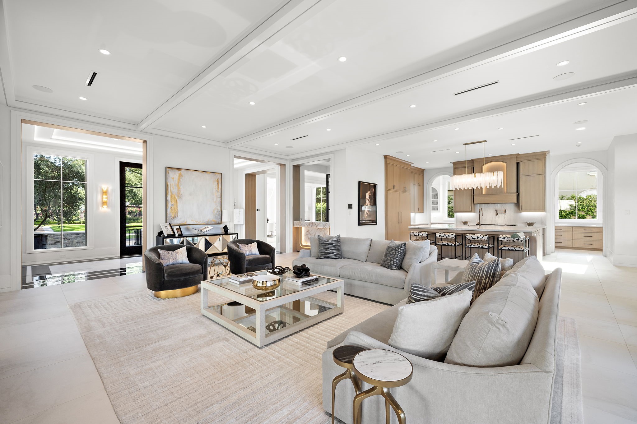3649 Chevy Chase Drive Houston, TX 77019 - Photo 6 of 50 Soaring ceilings and natural light highlight Venetian plaster, marble floors, and a dramatic fireplace. Wood-detailed casements add warmth and flow.