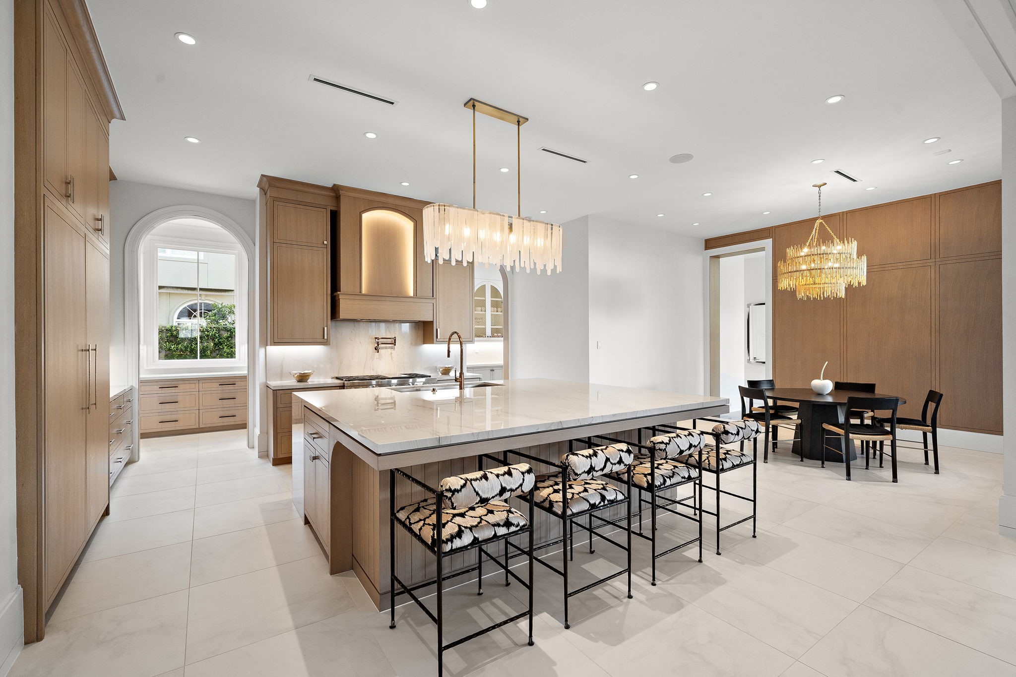3649 Chevy Chase Drive Houston, TX 77019 - Photo 7 of 50 A culinary space as beautiful as it is functional, anchored by a striking 9’x8’ Mont Blanc quartzite waterfall island with light-toned custom cabinetry and professional-grade appliances.