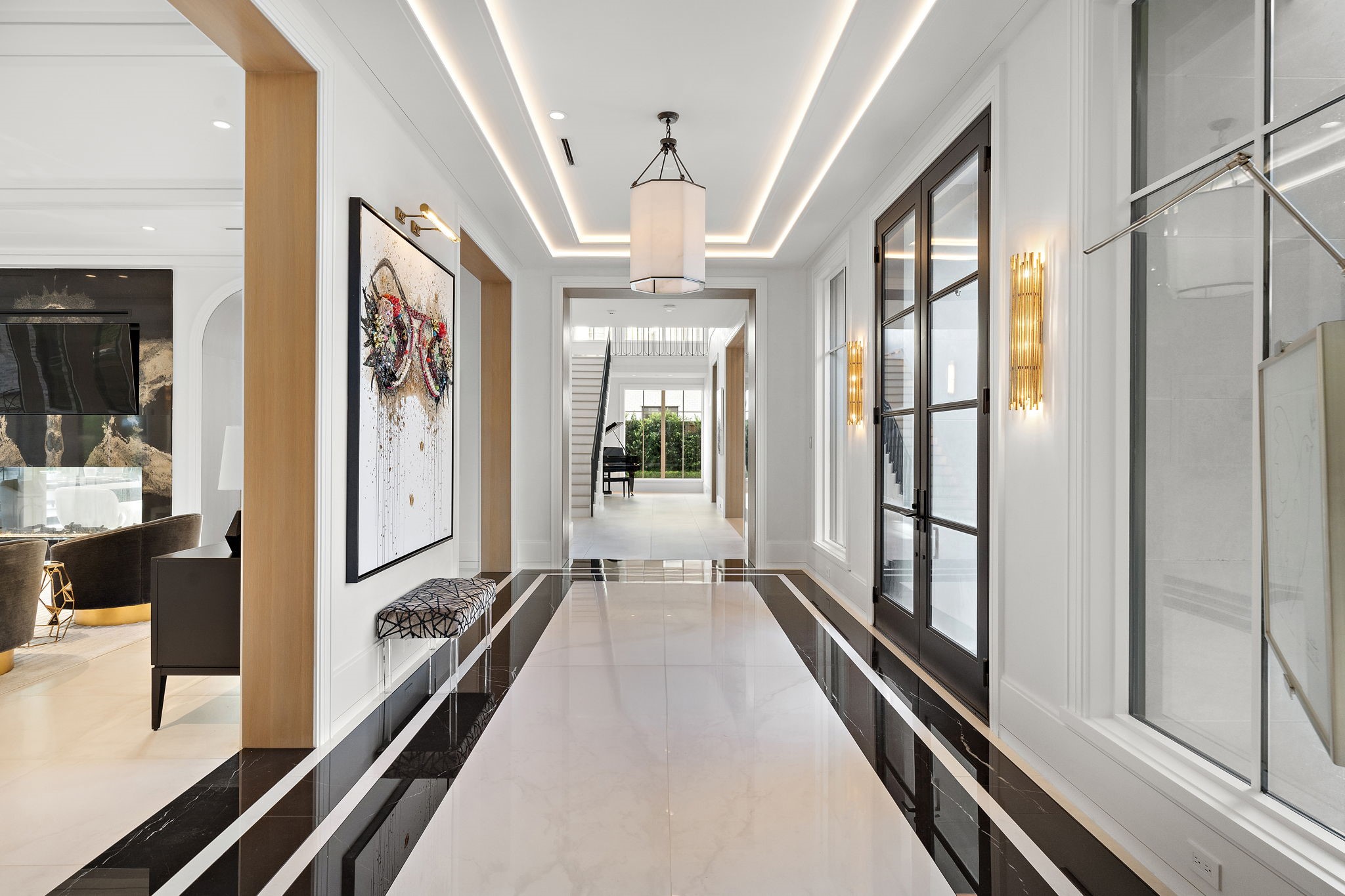 3649 Chevy Chase Drive Houston, TX 77019 - Photo 9 of 50 A grand entrance of artisan plaster, italian marble and sculpted cove lighting, where every detail signals timeless sophistication and sets the stage for what’s to come.