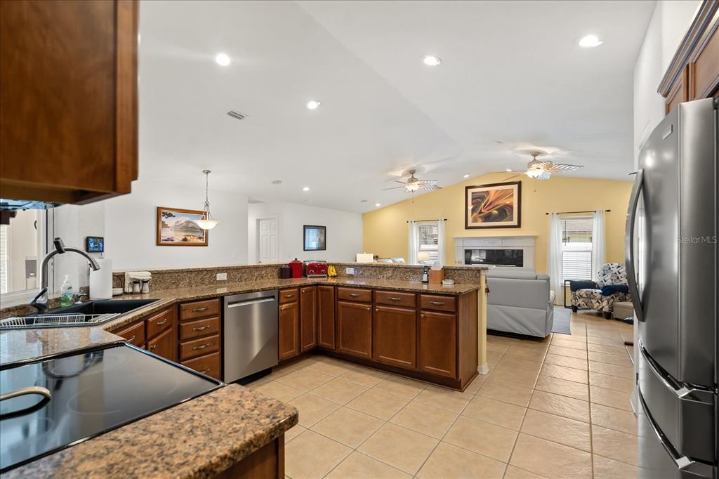 1254 Timberidge Loop South Lakeland, FL 33809 - Photo 11 of 36 a kitchen with stainless steel appliances granite countertop a sink and cabinets
