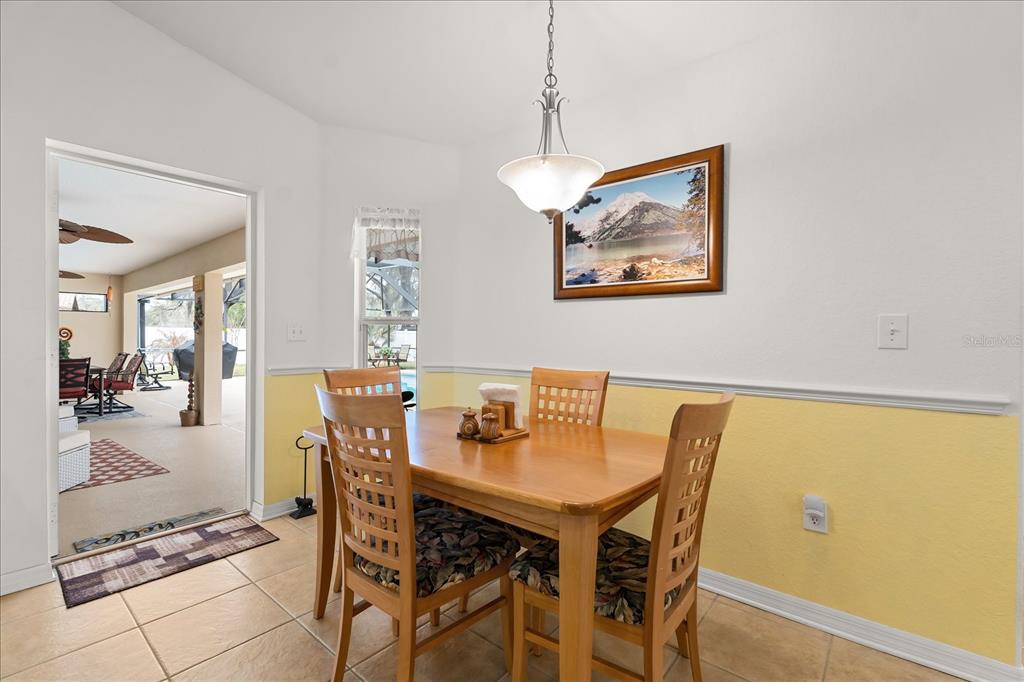 1254 Timberidge Loop South Lakeland, FL 33809 - Photo 16 of 36 a view of a dining room with furniture wooden floor and a chandelier