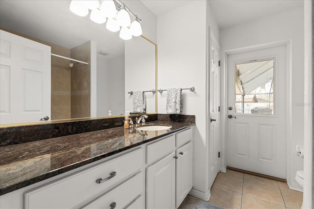 1254 Timberidge Loop South Lakeland, FL 33809 - Photo 26 of 36 a bathroom with a granite countertop double vanity sink and mirror