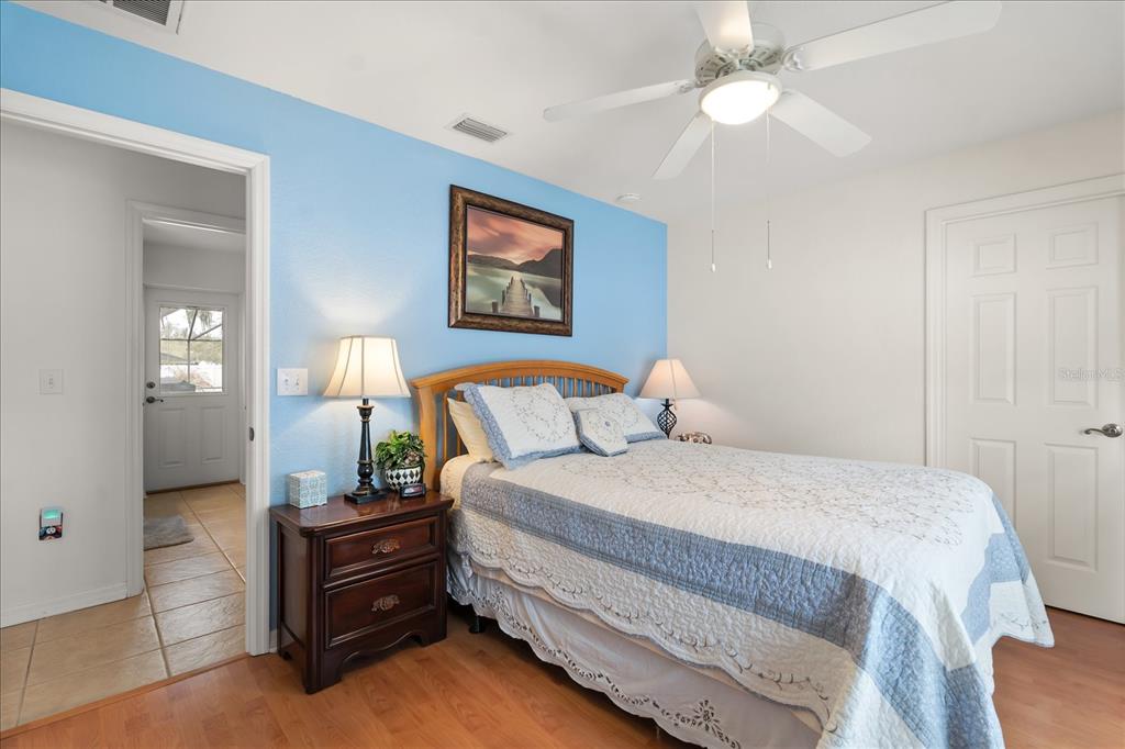 1254 Timberidge Loop South Lakeland, FL 33809 - Photo 28 of 36 a bedroom with a bed and a chandelier