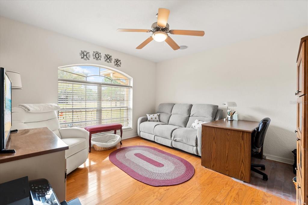 1254 Timberidge Loop South Lakeland, FL 33809 - Photo 9 of 36 a living room with furniture a rug and a chandelier