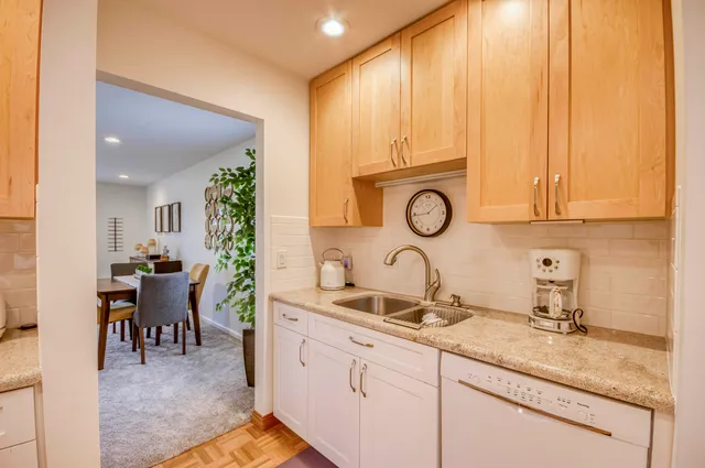 a kitchen with sink and cabinets
