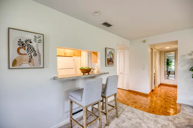 a view of a dining room with furniture and a window