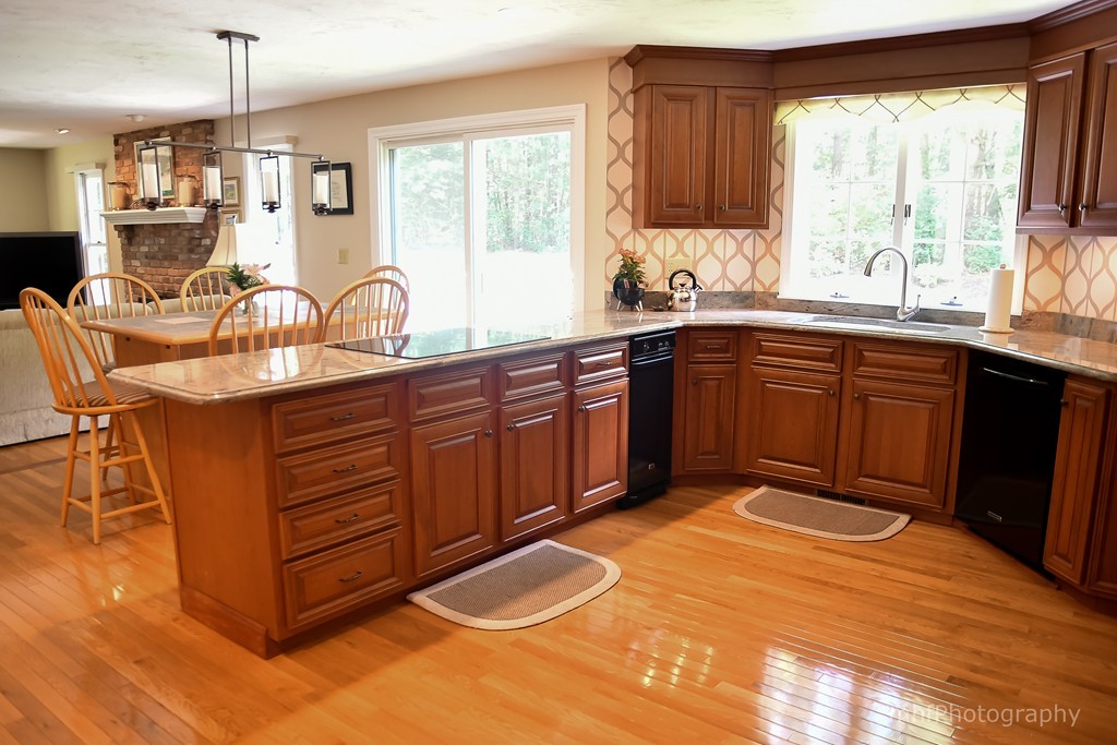82 Cranberry Circle Sudbury, MA 01776 - Photo 14 of 30 a kitchen with stainless steel appliances granite countertop a stove a sink dishwasher and a wooden cabinets