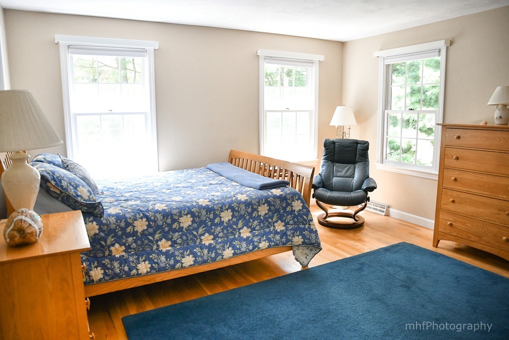 82 Cranberry Circle Sudbury, MA 01776 - Photo 18 of 30 a bedroom with a bed and chair