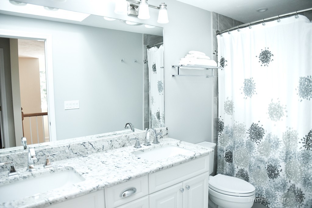 82 Cranberry Circle Sudbury, MA 01776 - Photo 21 of 30 a bathroom with a granite countertop sink toilet and shower