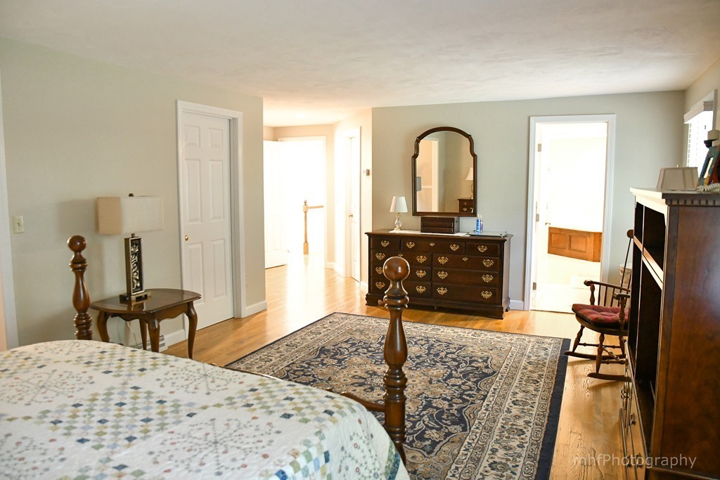 82 Cranberry Circle Sudbury, MA 01776 - Photo 22 of 30 a living room with furniture a flat screen tv and a fireplace