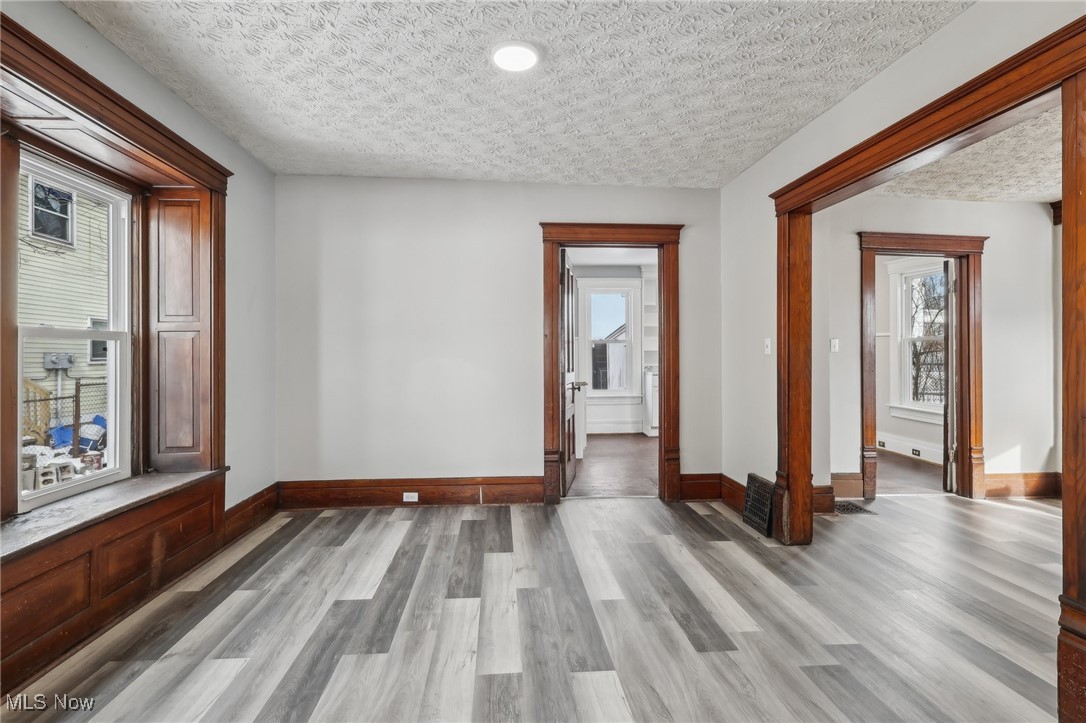 73 East York Street Akron, OH 44310 - Photo 6 of 36 Corridor with light wood-type flooring and a textured ceiling
