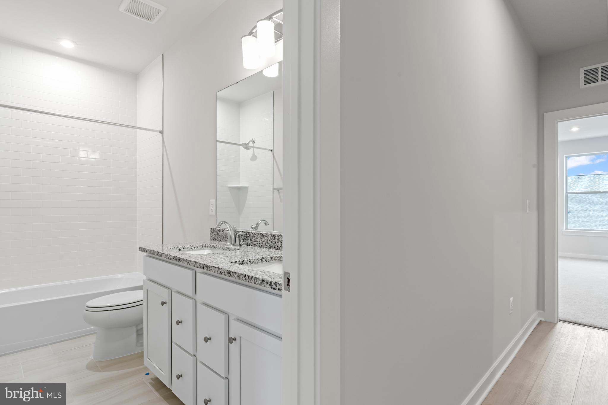 2152 Glacier Road, Unit 66 Herndon, VA 20170 - Photo 41 of 50 a bathroom with a granite countertop sink toilet and shower
