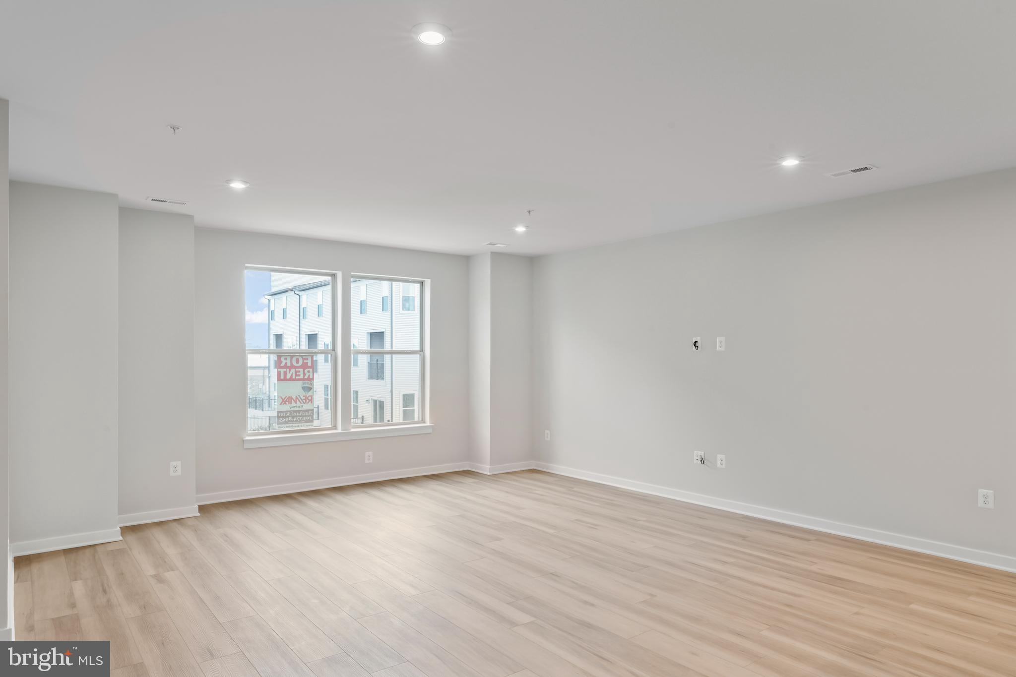 2152 Glacier Road, Unit 66 Herndon, VA 20170 - Photo 5 of 50 an empty room with wooden floor and windows