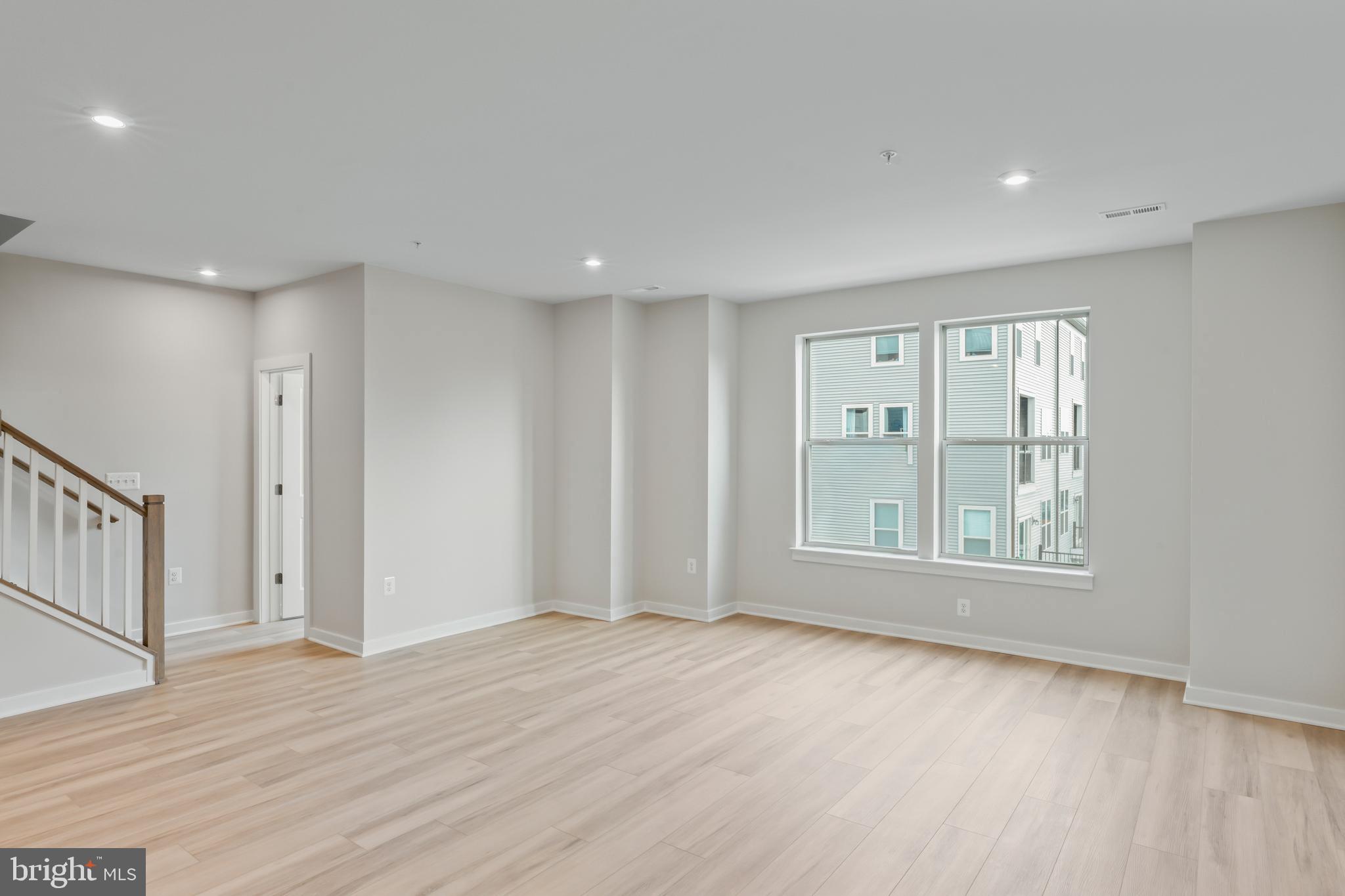 2152 Glacier Road, Unit 66 Herndon, VA 20170 - Photo 8 of 50 a view of an empty room with wooden floor and a window