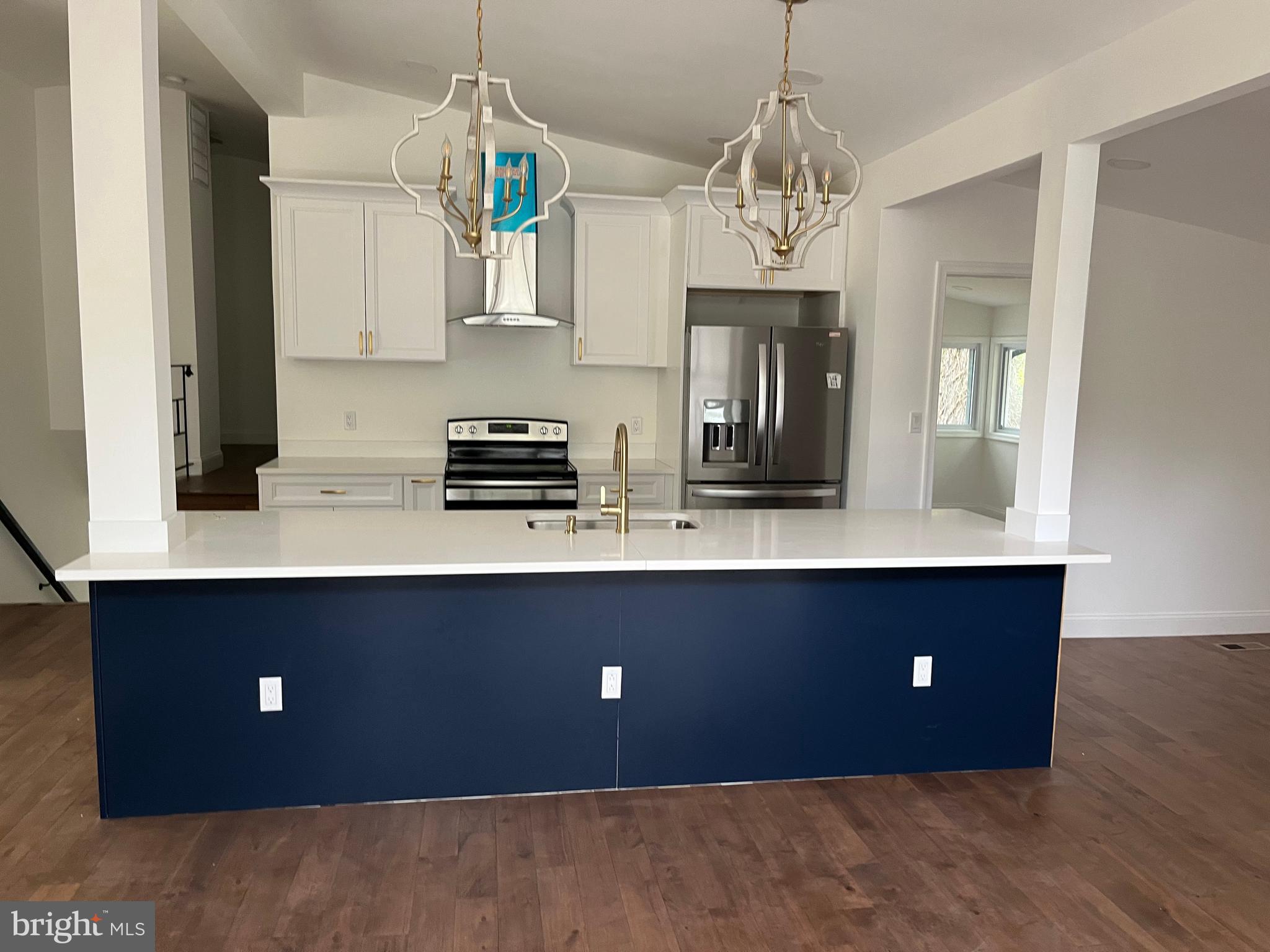a kitchen with a sink and chandelier
