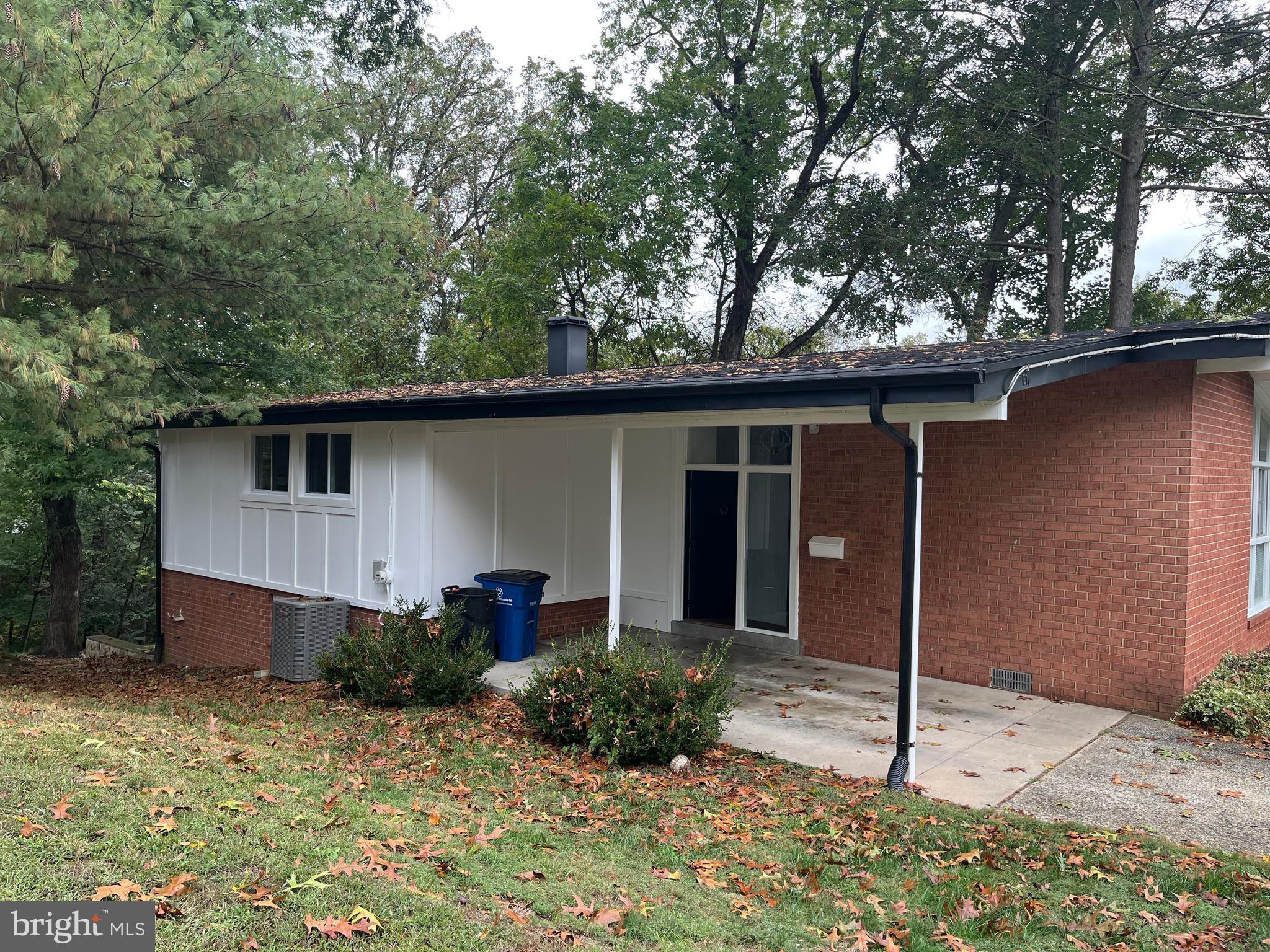 611 Winona Court Silver Spring, MD 20902 - Photo 11 of 15 a backyard of a house with potted plants and large tree
