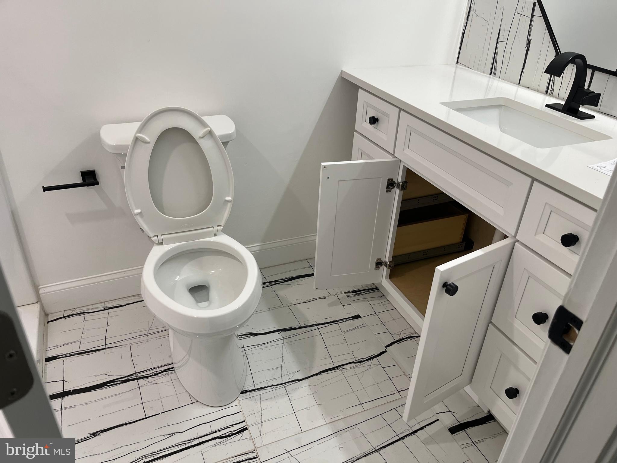 611 Winona Court Silver Spring, MD 20902 - Photo 3 of 15 a bathroom with a toilet sink and mirror