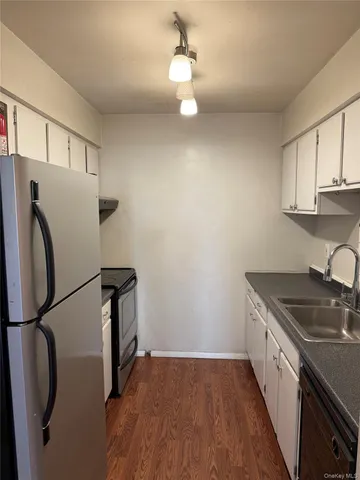 a kitchen with stainless steel appliances a refrigerator a sink and a stove