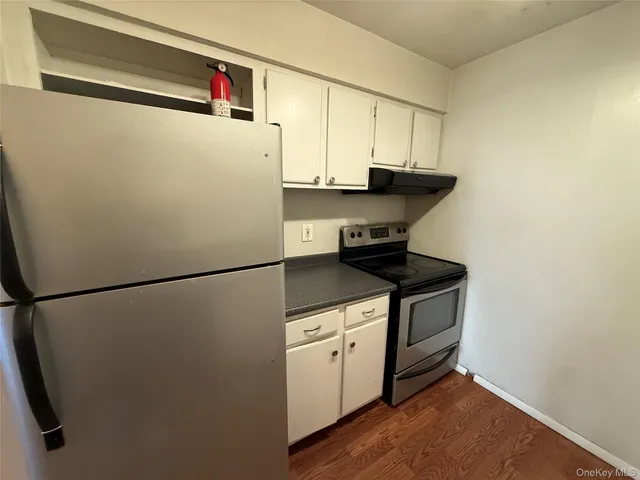 a white refrigerator freezer sitting inside of a kitchen